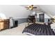 Cozy bedroom with neutral carpet, TV, and a two-tone gray and white color scheme at 271 Double Gate Ct, Sugar Hill, GA 30518