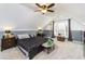 Bright bedroom featuring plush carpeting, gray accent wall, and a window with natural light at 271 Double Gate Ct, Sugar Hill, GA 30518