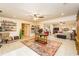 Bright living room features neutral paint, tile flooring, and an area rug to define the seating area at 271 Double Gate Ct, Sugar Hill, GA 30518