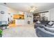 Open-concept living room with a gray sectional, a dark accent wall, and views to the kitchen at 271 Double Gate Ct, Sugar Hill, GA 30518