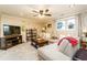 Cozy living room with plush seating, a large TV, and natural light from the windows at 271 Double Gate Ct, Sugar Hill, GA 30518