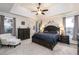 Calm main bedroom featuring a tray ceiling, plush carpet, and matching furniture set at 271 Double Gate Ct, Sugar Hill, GA 30518