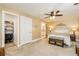 Comfortable main bedroom boasting neutral colors, a ceiling fan, and natural light at 271 Double Gate Ct, Sugar Hill, GA 30518