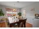 Traditional dining room featuring a wood table, cushioned chairs, and a window for natural light at 2773 Saddle Horn Place Southwest Pl, Snellville, GA 30039