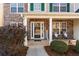 Charming home entrance with stone facade, white pillars, and welcoming front porch decor at 2773 Saddle Horn Place Southwest Pl, Snellville, GA 30039