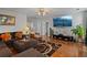 Living room featuring a large sectional sofa, television, hardwood floors, and decorative plants at 2773 Saddle Horn Place Southwest Pl, Snellville, GA 30039