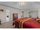 Well-lit bedroom features neutral walls and carpeting, with doorways leading to additional rooms at 2773 Saddle Horn Place Southwest Pl, Snellville, GA 30039