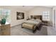 Relaxing main bedroom with a neutral color scheme, decorative wall art, and bright natural light at 5885 Waggoner Cv, Rex, GA 30273