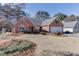 Landscaped front yard and brick facade with a large front window at 1050 Sunny Field Ct, Lawrenceville, GA 30043