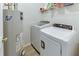 Functional laundry room with modern washer, dryer, and water heater and shelving offering a practical space at 1050 Sunny Field Ct, Lawrenceville, GA 30043