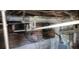 Pipes run throughout the basement, with a brick support wall visible at 1385 Womack Ave, Atlanta, GA 30344