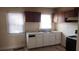 Traditional kitchen features a double stainless steel sink, two windows, and white cabinets underneath the counter at 1385 Womack Ave, Atlanta, GA 30344