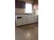 Kitchen featuring white cabinets, a double sink under a window and dark brown overhead cabinets at 1385 Womack Ave, Atlanta, GA 30344