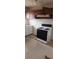 Kitchen features a gas stove, white cabinets and dark brown overhead cabinets at 1385 Womack Ave, Atlanta, GA 30344