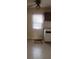 Kitchen featuring a ceiling fan, window, and white cabinets with dark brown overhead cabinets at 1385 Womack Ave, Atlanta, GA 30344