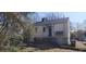 Shows a side and rear of the home exterior with overgrown yard, needing yard work at 1385 Womack Ave, Atlanta, GA 30344