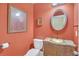 Powder room with peach walls, tiled floor, and decorative sink and mirror at 2740 Heritage Bend Ct, Grayson, GA 30017
