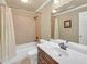 Well-lit bathroom featuring a shower-tub combo with tile surround and single vanity with a solid-surface countertop at 2740 Heritage Bend Ct, Grayson, GA 30017