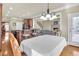 Open dining area with hardwood floors, with bar and fireplace in background at 2740 Heritage Bend Ct, Grayson, GA 30017