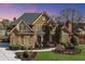 Stately brick home with a manicured lawn, lush landscaping, and a winding walkway at 2740 Heritage Bend Ct, Grayson, GA 30017