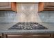 Granite countertops highlight the cooktop of this kitchen with tile backsplash at 2740 Heritage Bend Ct, Grayson, GA 30017