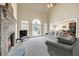 An open living room boasts a stone fireplace, high ceiling, and seamless flow to the dining area at 2740 Heritage Bend Ct, Grayson, GA 30017