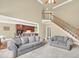 Open floor plan living room with plush seating and access to the kitchen via breakfast bar at 2740 Heritage Bend Ct, Grayson, GA 30017