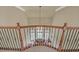 View of the foyer and living room from the staircase, enhanced by detailed wrought iron railing at 2740 Heritage Bend Ct, Grayson, GA 30017
