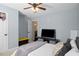 Bedroom with a ceiling fan, bed, and a television on a stand at 50 Berkshire Run, Covington, GA 30016