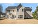 Back exterior view of a two-story home with a patio and a lawn at 1200 St James Pl, Loganville, GA 30052