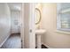 Half bathroom featuring pedestal sink and window at 1200 St James Pl, Loganville, GA 30052