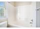 Bathroom with a tub and a shower combination and a large window at 1200 St James Pl, Loganville, GA 30052