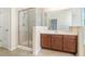 Bright bathroom featuring a glass shower and a vanity with a large mirror at 1200 St James Pl, Loganville, GA 30052