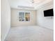 Carpeted bedroom featuring a ceiling fan and a window overlooking the backyard at 1200 St James Pl, Loganville, GA 30052