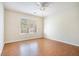 Bedroom with hardwood flooring, a ceiling fan, and a large window at 1200 St James Pl, Loganville, GA 30052