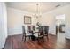 Elegant dining room featuring a glass table, hardwood floors, and a stylish chandelier at 1200 St James Pl, Loganville, GA 30052