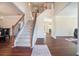 Spacious foyer with staircase and wood flooring, leading to the living spaces at 1200 St James Pl, Loganville, GA 30052