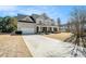 Beautiful two-story home with a covered front porch, lush landscaping, and attached garage at 1200 St James Pl, Loganville, GA 30052