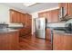 Spacious kitchen featuring stainless steel appliances, wood cabinets, and hardwood floors at 1200 St James Pl, Loganville, GA 30052