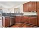 Cozy kitchen with wood cabinets and stainless steel dishwasher at 1200 St James Pl, Loganville, GA 30052