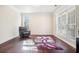 Cozy living room with natural light, wood floors, and ample space at 1200 St James Pl, Loganville, GA 30052