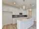 Bright kitchen showcasing white cabinetry, a center island with stone countertops, and herringbone tile backsplash at 2761 Sandy Rd, Conyers, GA 30013