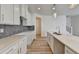 Modern kitchen featuring white cabinets, a center island, stone countertops, and a stylish gray tile backsplash at 2761 Sandy Rd, Conyers, GA 30013