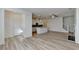 Bright living room featuring the kitchen, an electric fireplace, and a modern staircase at 2761 Sandy Rd, Conyers, GA 30013