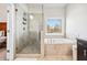 Elegant bathroom features a glass shower and soaking tub with views at 3185 Quinn Pl, Atlanta, GA 30341