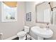 Powder room featuring pedestal sink, modern fixtures, and natural light at 3185 Quinn Pl, Atlanta, GA 30341