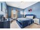 Well-lit bedroom with blue walls, large window, and comfortable blue bed at 3185 Quinn Pl, Atlanta, GA 30341