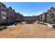 A common green space surrounded by brick townhomes, featuring benches and walkways at 3185 Quinn Pl, Atlanta, GA 30341