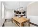 Open dining area with a view to the kitchen, featuring modern lighting and neutral tones at 3185 Quinn Pl, Atlanta, GA 30341