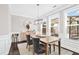 Elegant dining room with wainscoting, modern light fixture, and ample natural light at 3185 Quinn Pl, Atlanta, GA 30341